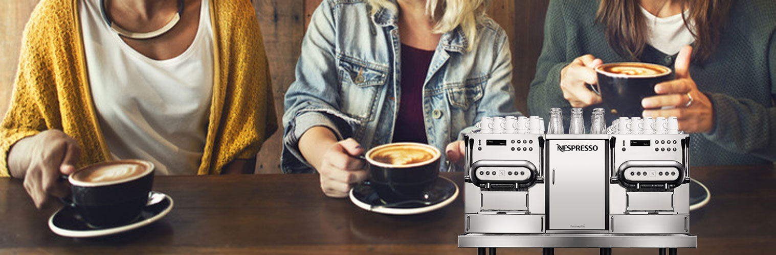 nespresso machine and three women enjoying espresso