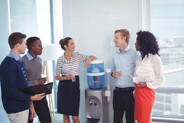 Office Water and Ice Solutions in Dallas, coworkers surrounding a water cooler