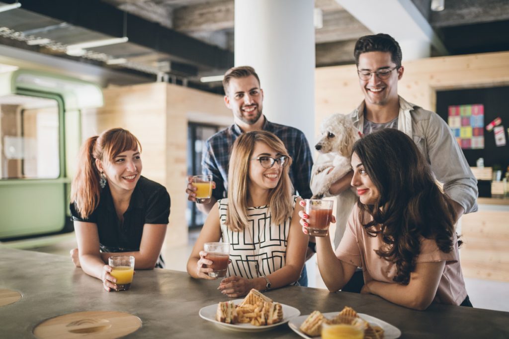 Happy employees sharing healthy break room snacks