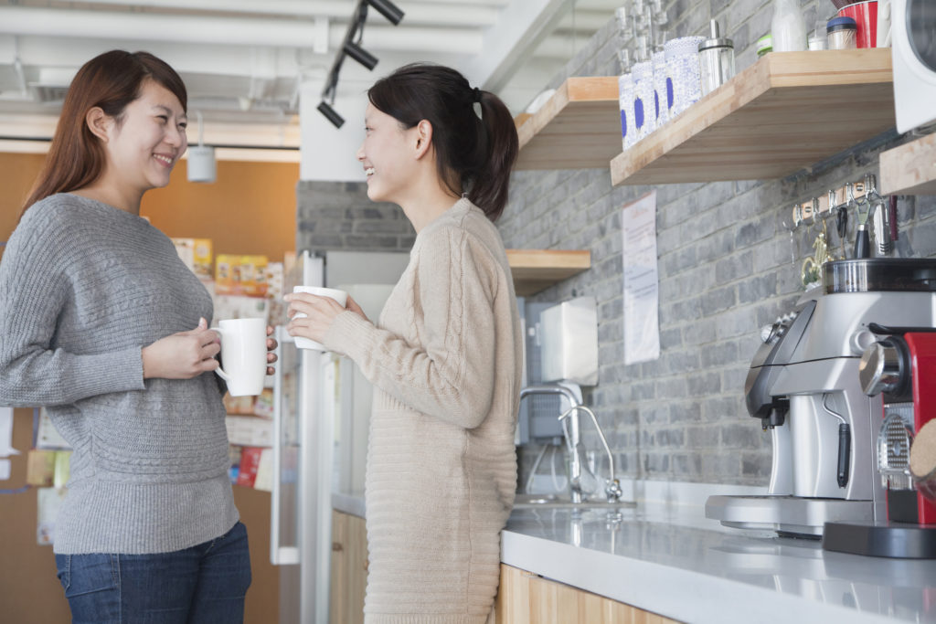 Businesswomen sharing office coffee break