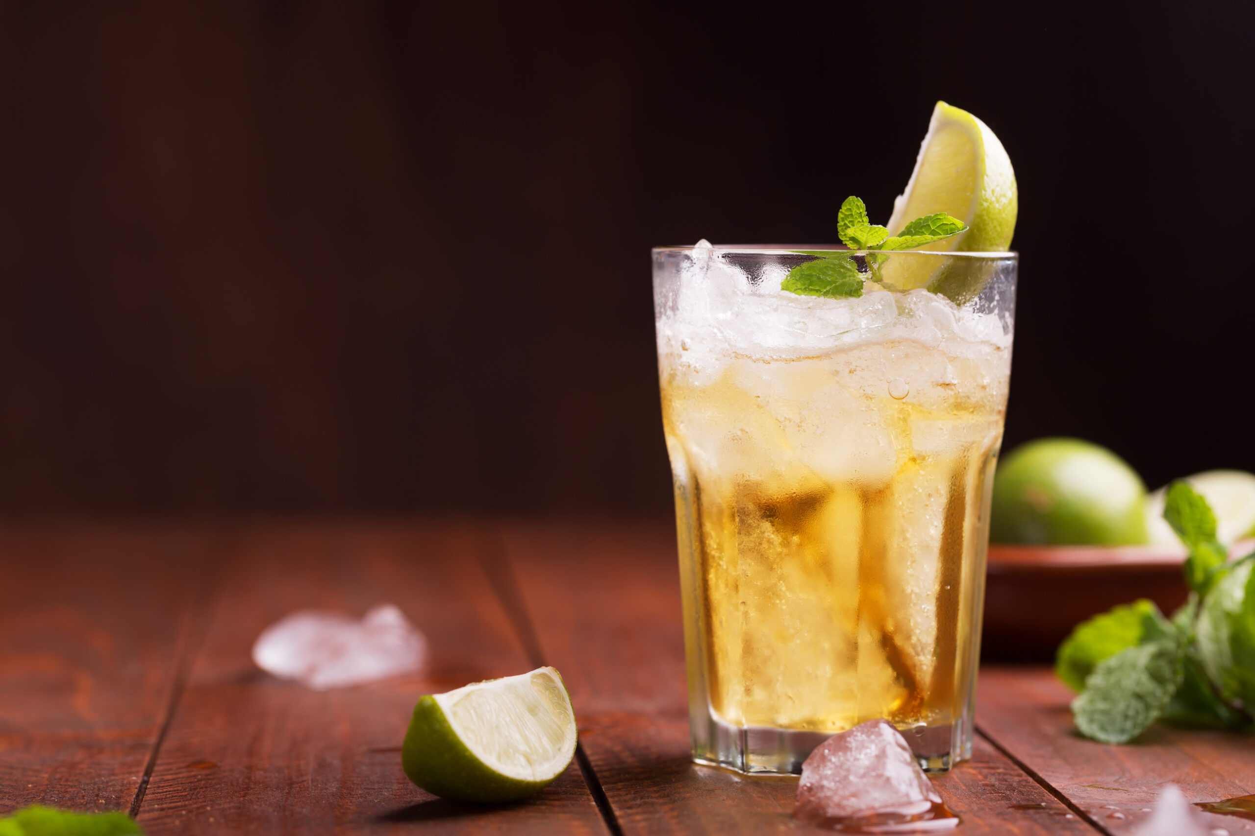 Fresh cocktail prepared with ginger beer, lime and ice. Beverage on the table